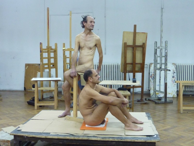 A naked man poses artists