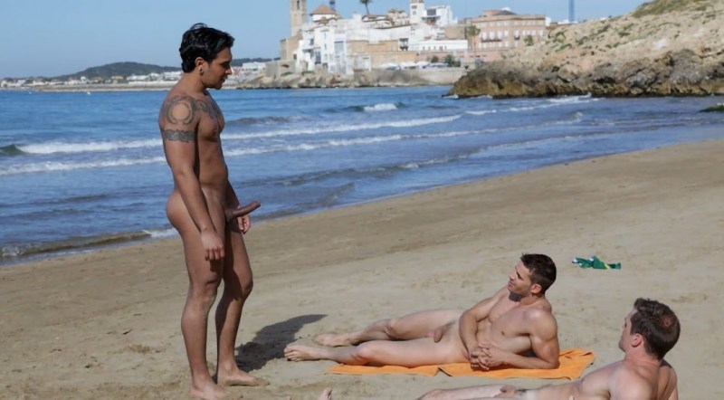 Naked boys on the beach sunbathe