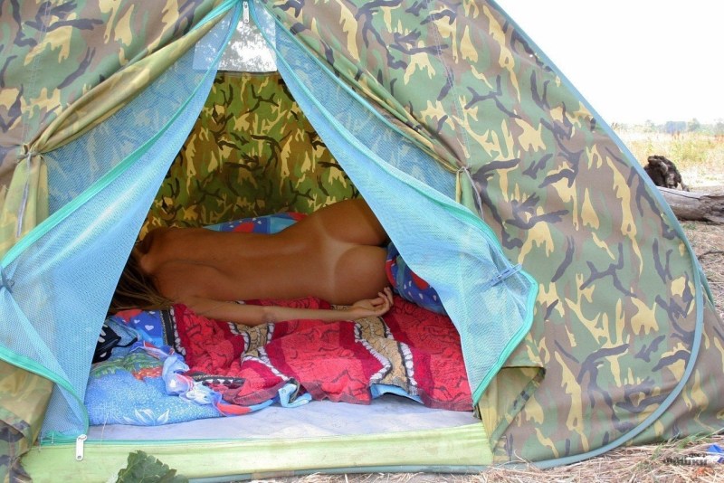 Naked tourist in a tent