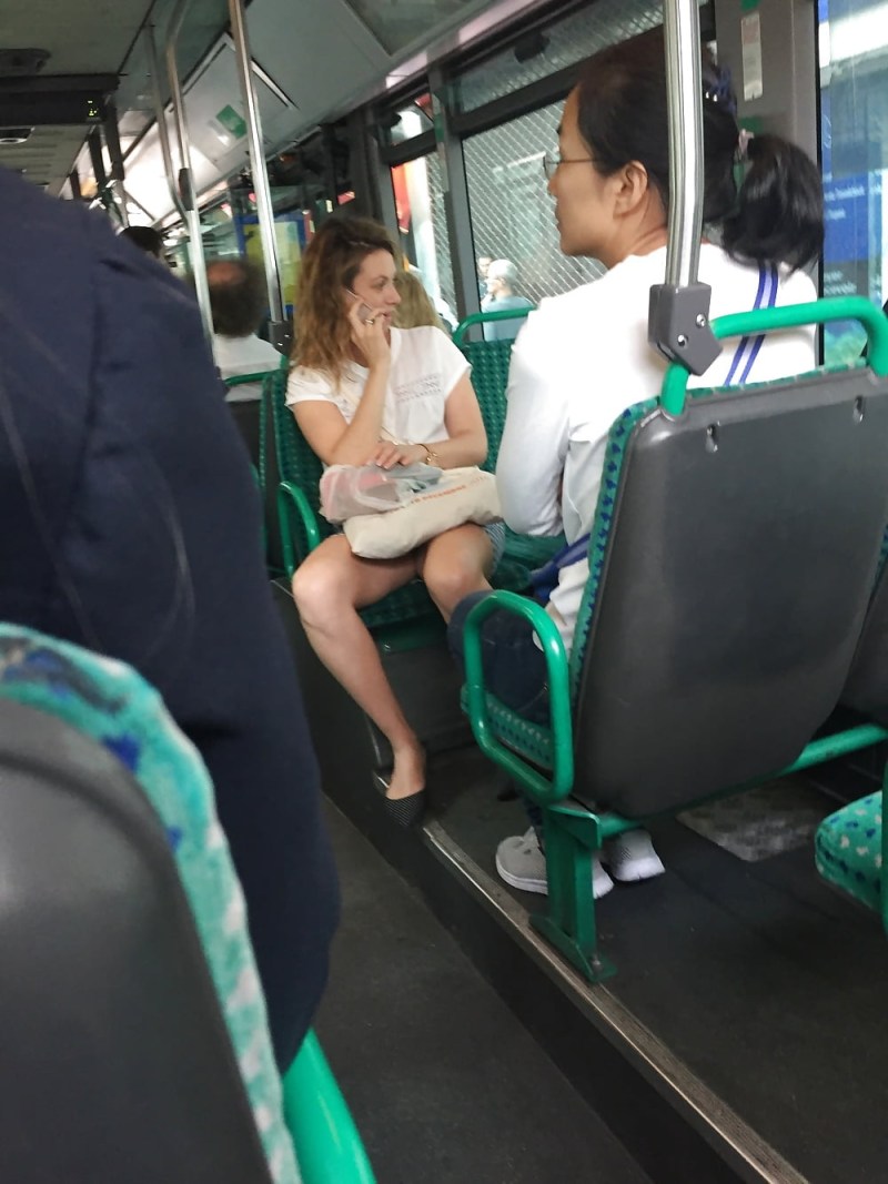 The guy sits with his legs apart
