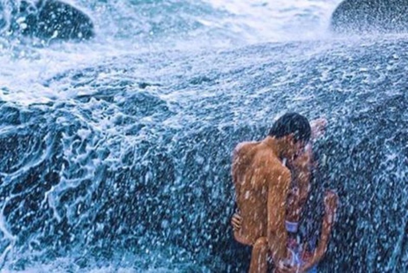 A man under a waterfall