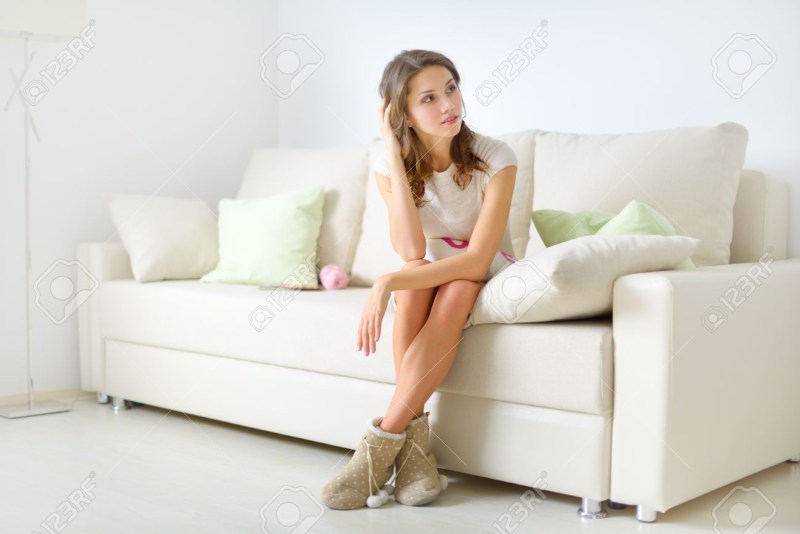 White girl sits on the couch