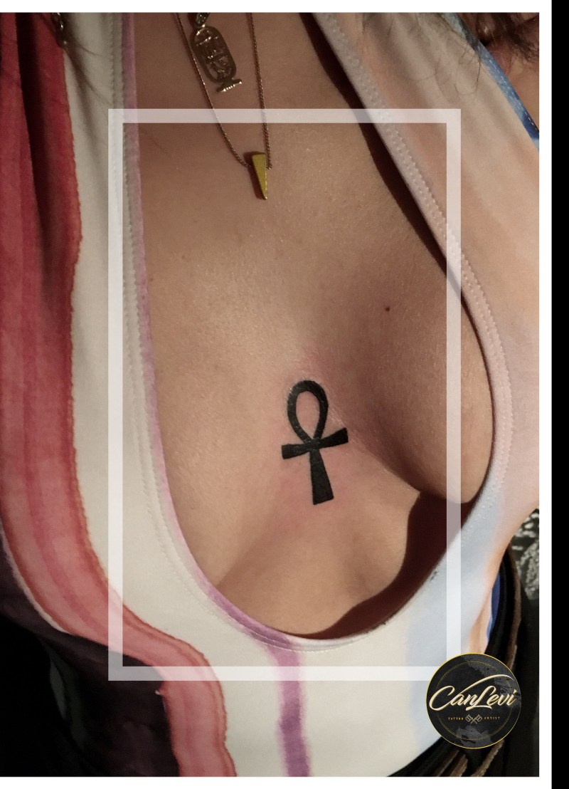 Tattoo cross on the ribs