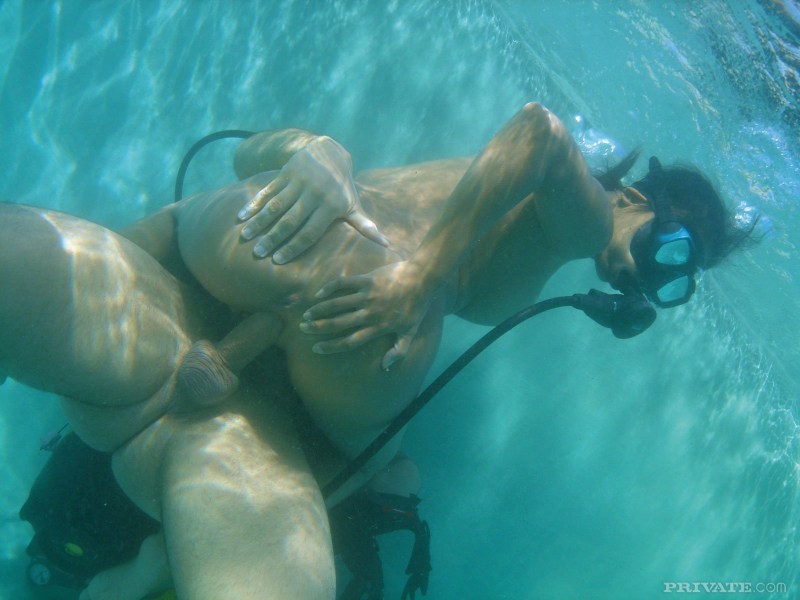 Naked women with flippers underwater