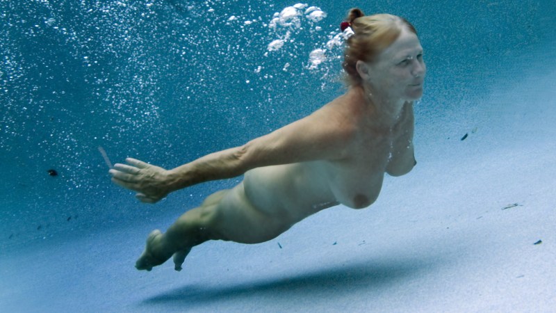 Naked women with flippers underwater