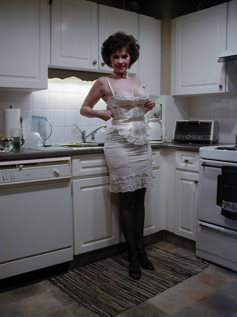 Old naked women in the kitchen