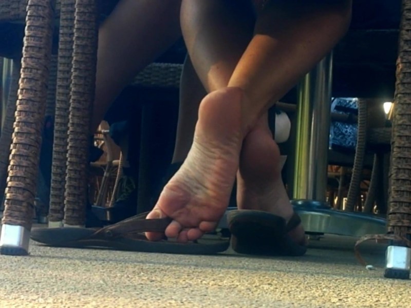 Barefoot legs under the table