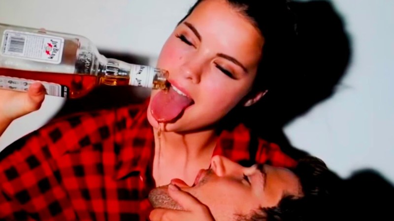Guy and girl drink alcohol