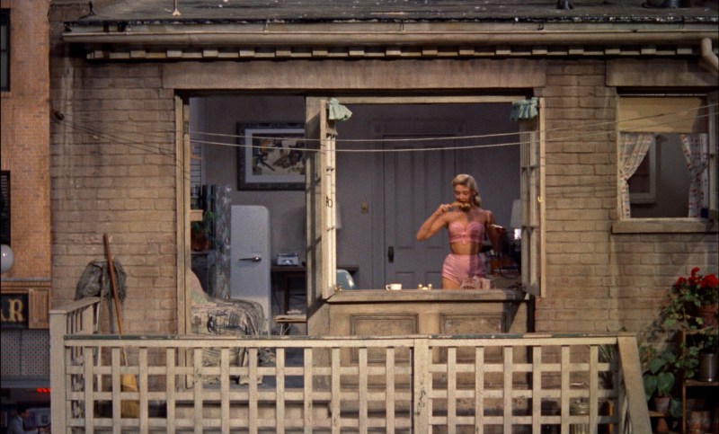 The neighbor sunbathes on the balcony