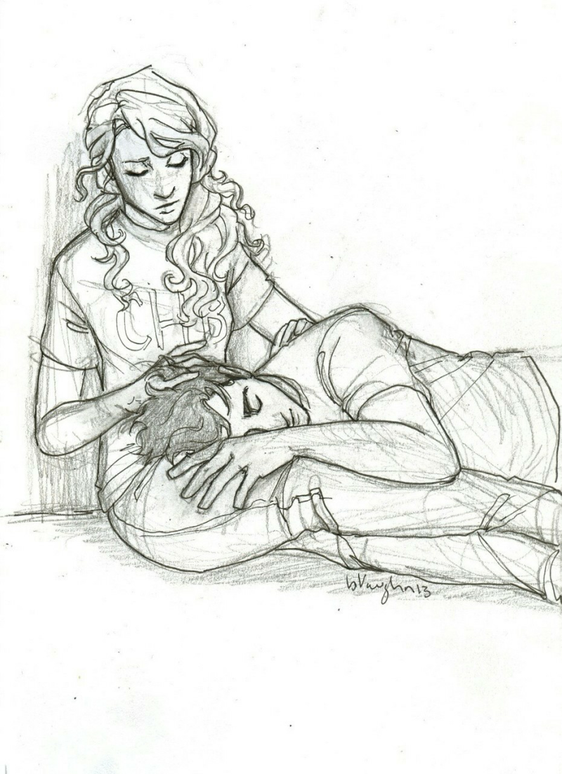 The girl lies a drawing with a pencil