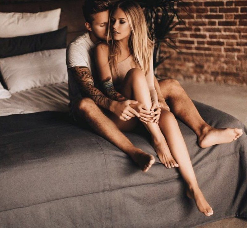 The girl smokes on the balcony