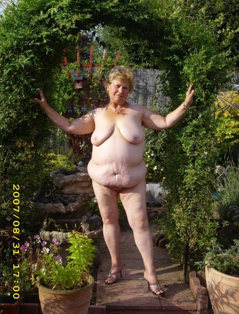 Old woman naked in the garden