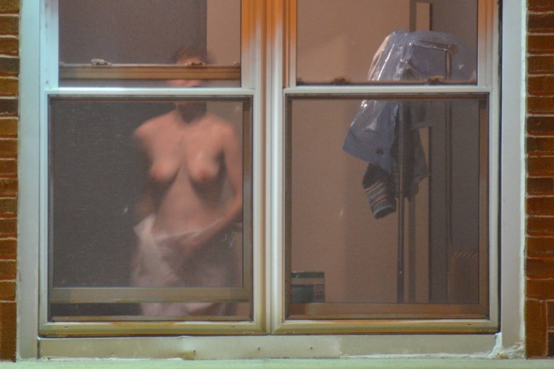 Naked women in the windows of houses