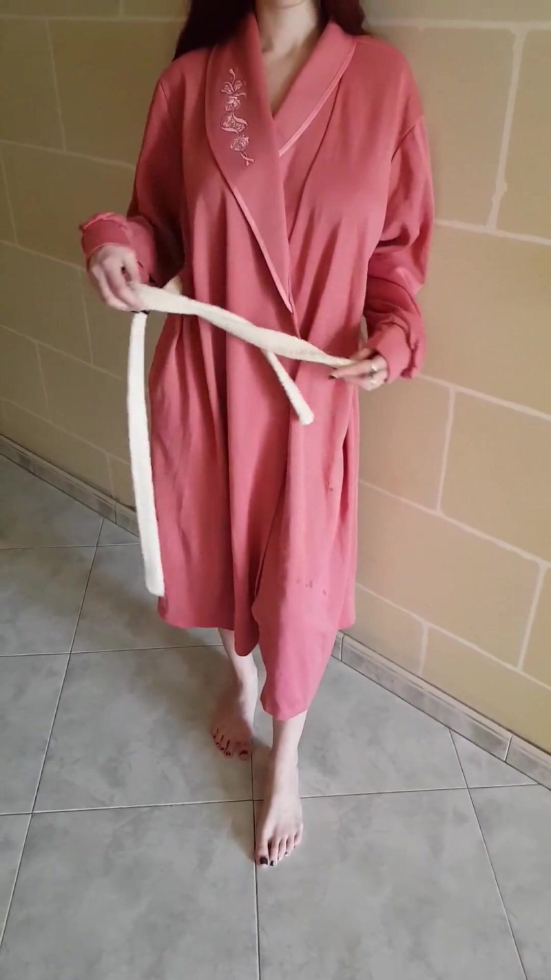 Girl in a dressing gown undresses