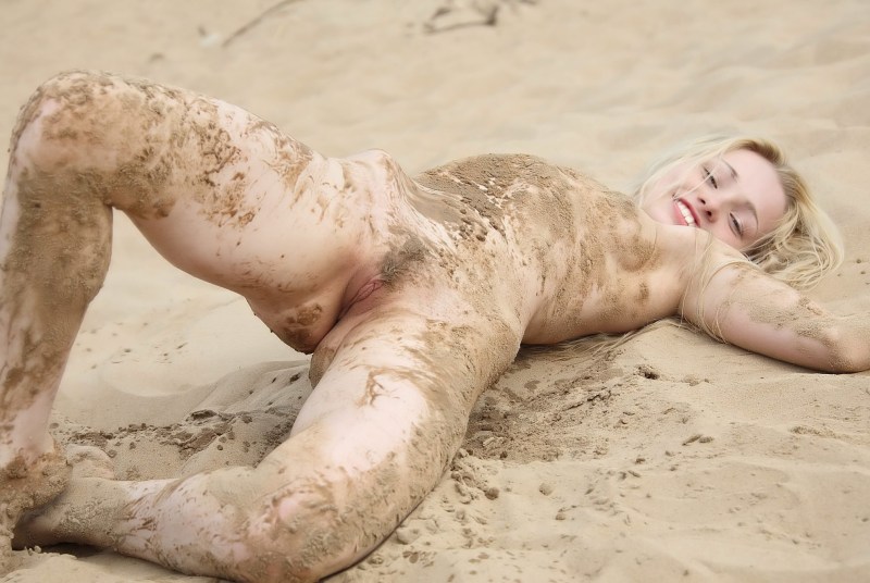 Naked women are lying in mud