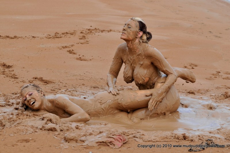 Naked women bathe in the mud