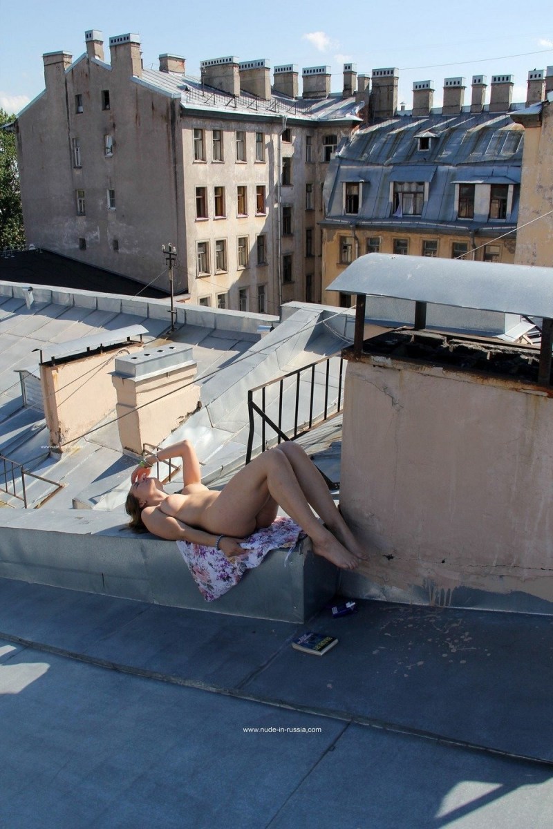Sunbathes naked on the roof