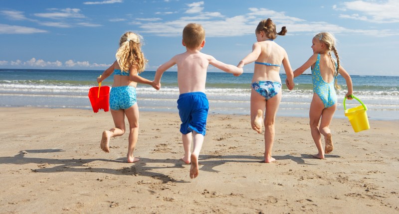 Children at sea sunbathe girls