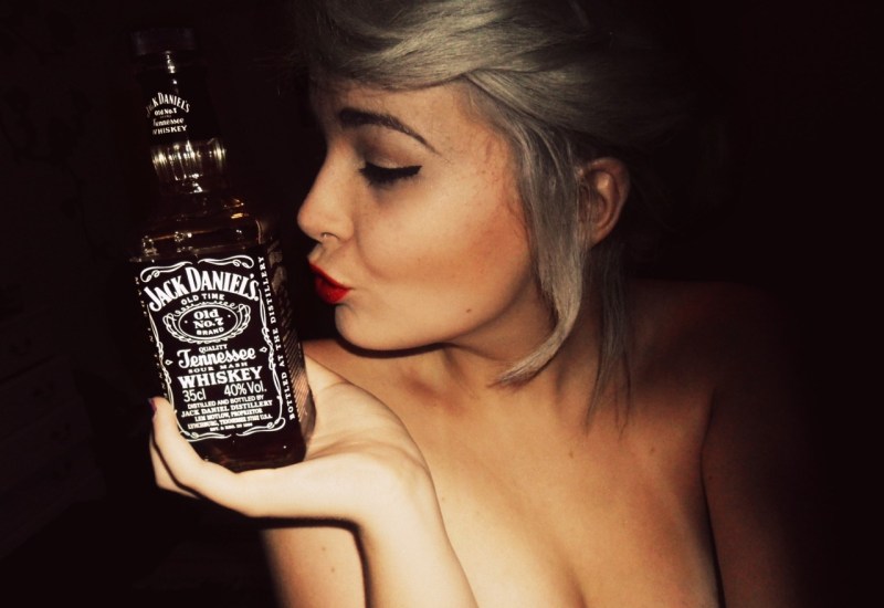 Girl in a bath with a glass