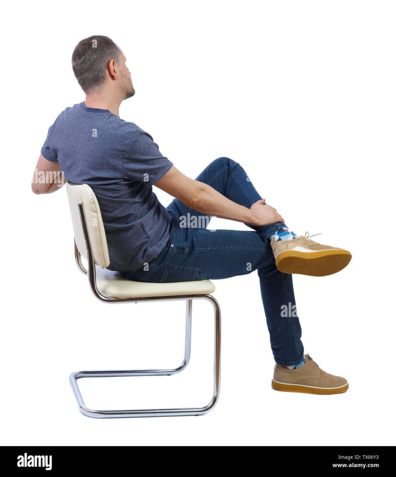 A man fidgets in a chair