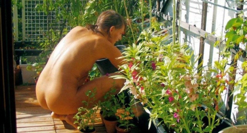 Naked woman in a greenhouse