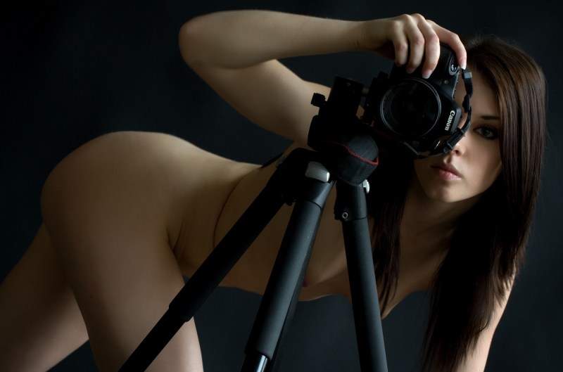 Naked woman with a camera