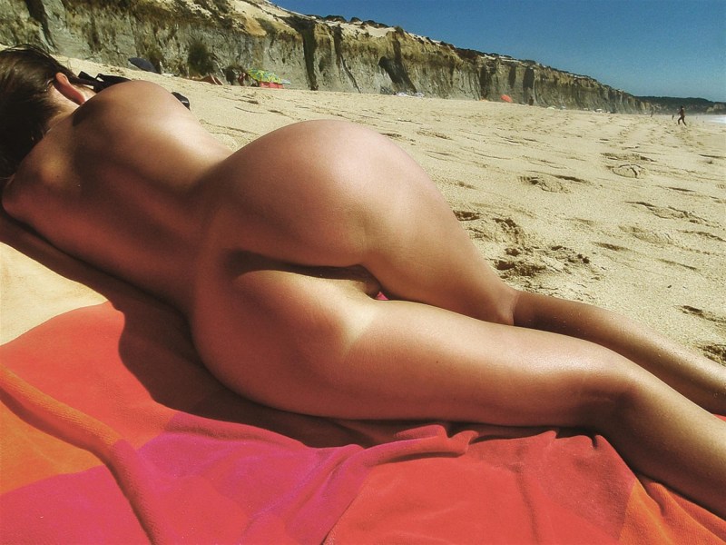 Naked women hide on the beach