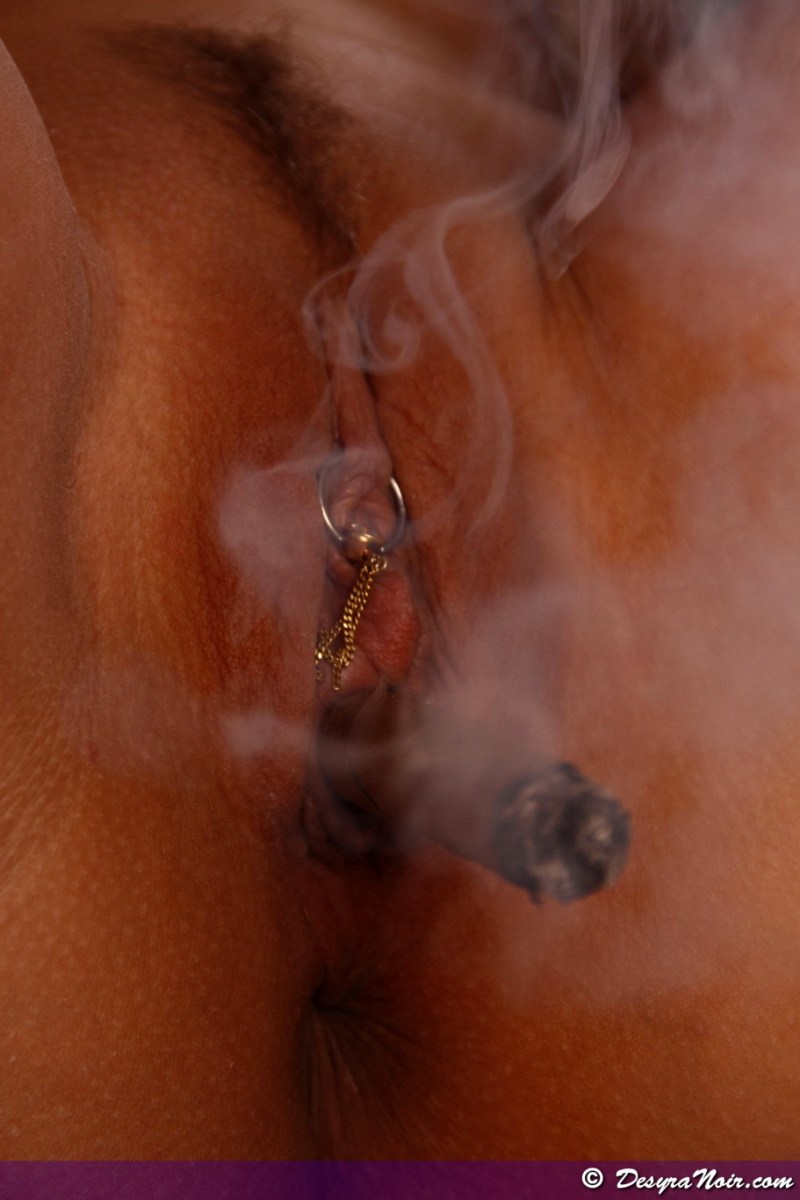 The woman smokes the vagina