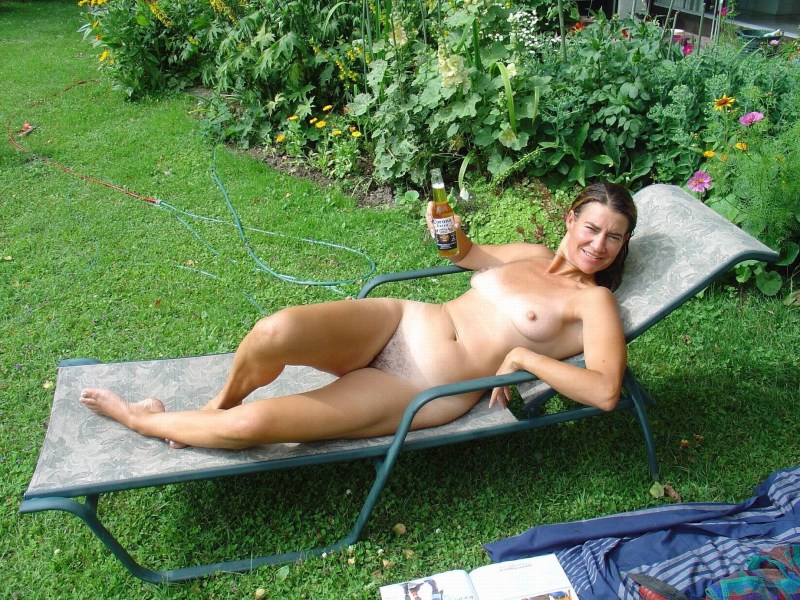 Naked wife sunbathes in the country