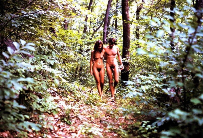 A naked man walks through the forest