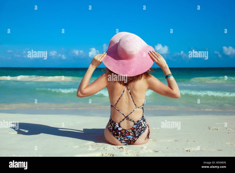 Girl in a hat on the beach