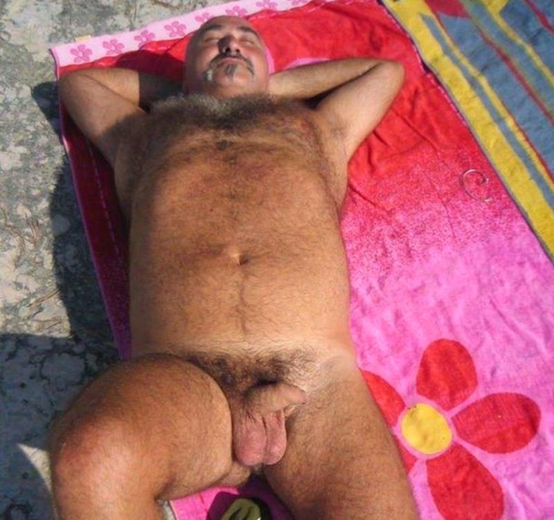 A naked hairy man sleeps