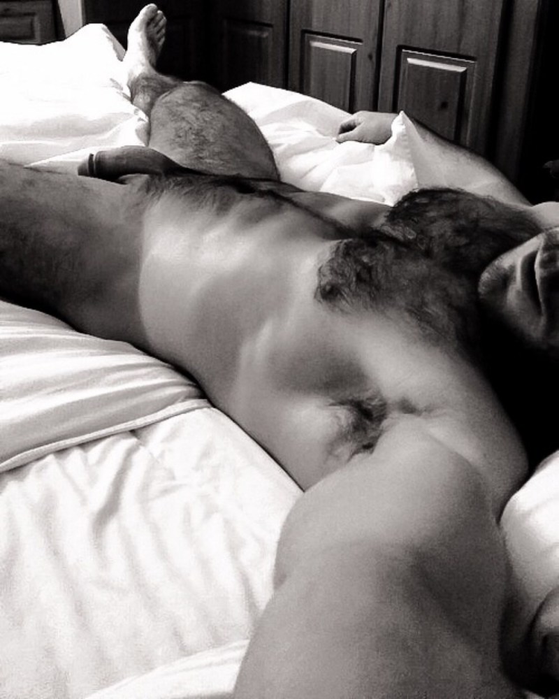 A naked hairy man sleeps