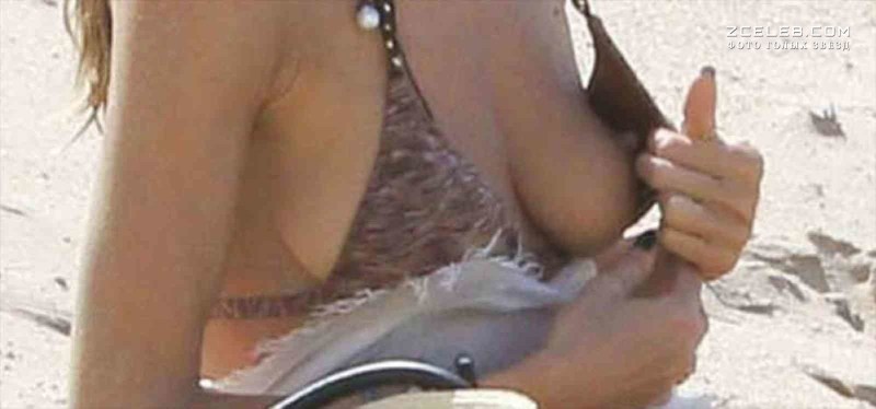 Lit up boobs in a bra on the beach