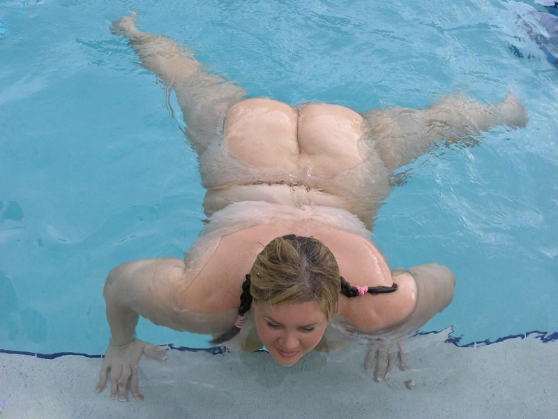 Naked fat woman by the pool