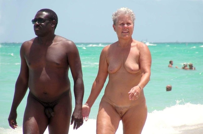 Nudist with blacks on the beach