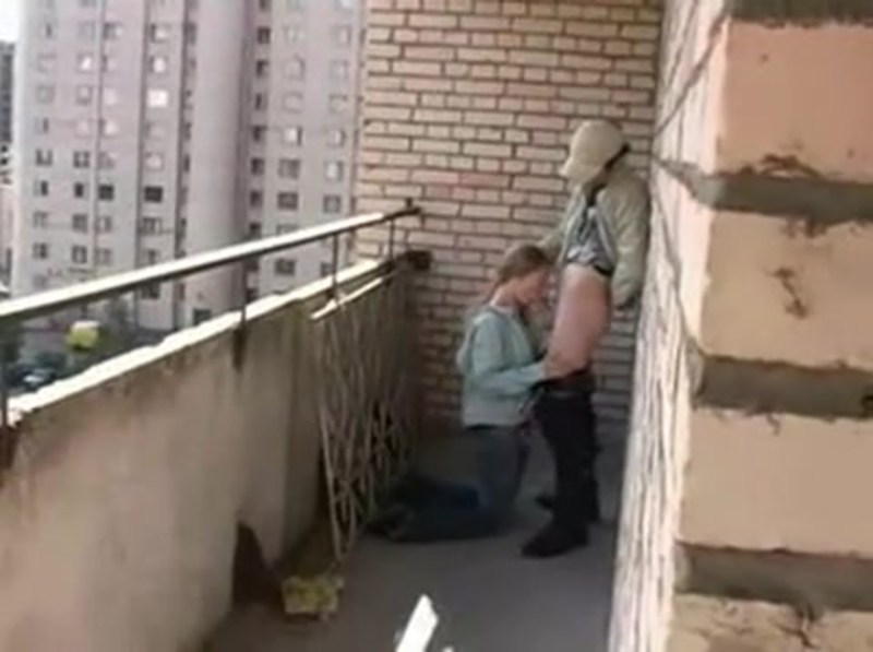 A friend sucks on the balcony