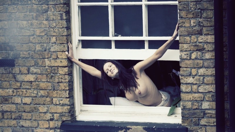 Naked women in the windows of houses