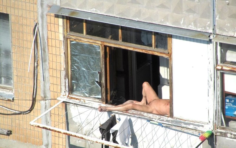 Sunbathing on the balcony naked