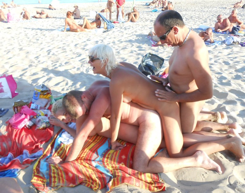 Swingers on a public beach