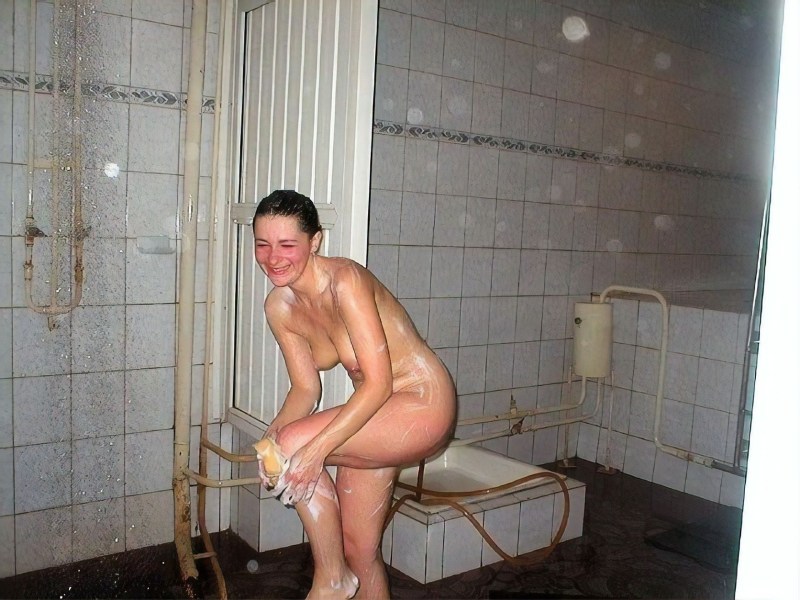 Naked women wash in a sauna in a shower