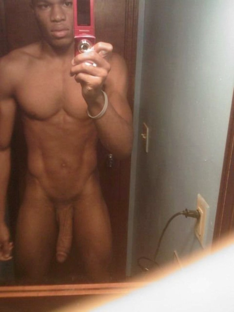 Naked guy in front of the mirror