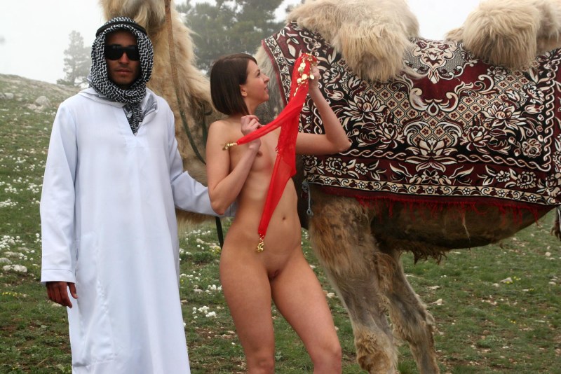 Naked with a camel in the desert