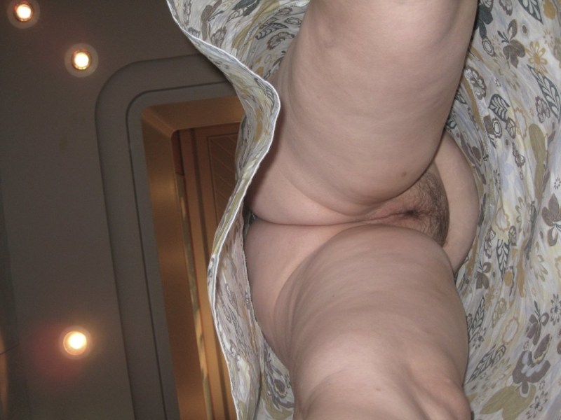 An elderly woman without panties below