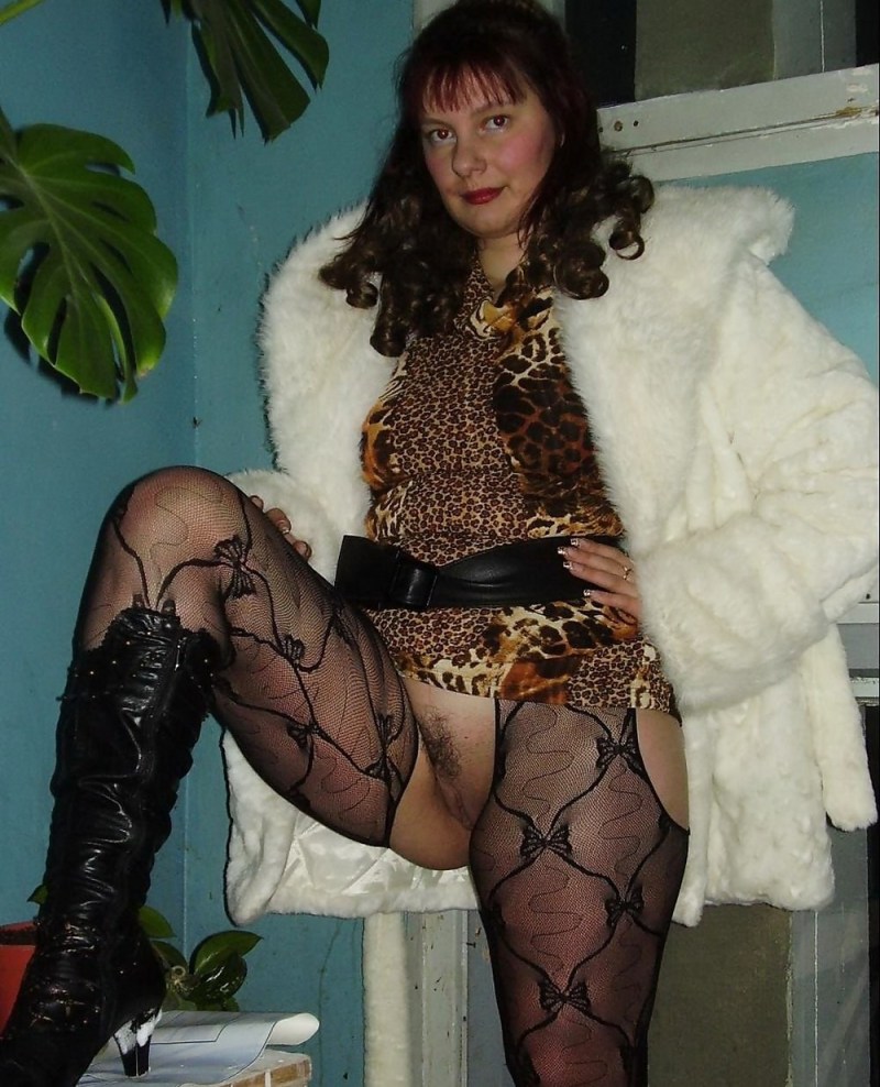 Naked wife in stockings and fur coat