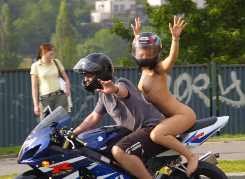 Naked on a motorcycle in a helmet