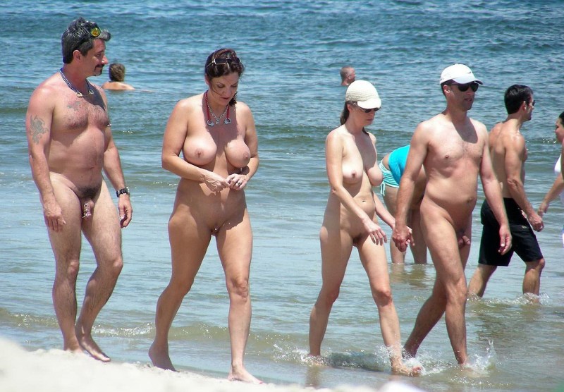 Naked people of different ages on the beach