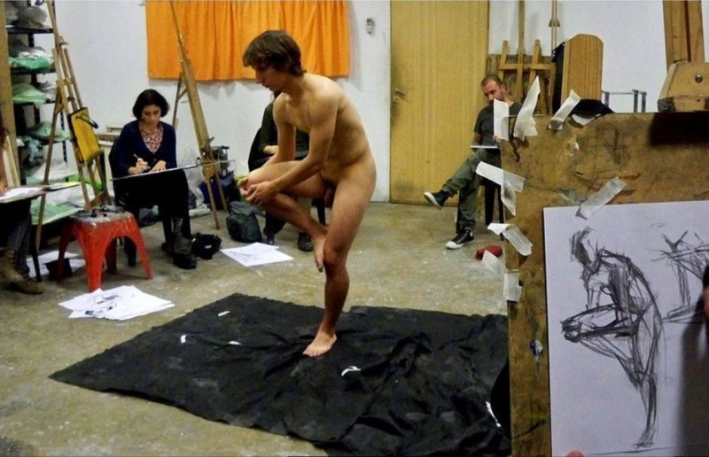 A naked man poses a model