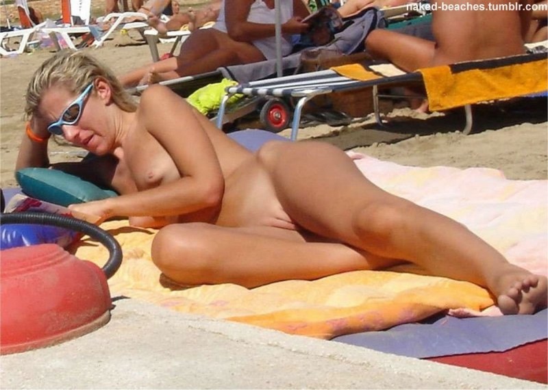 Girl on a public beach without panties