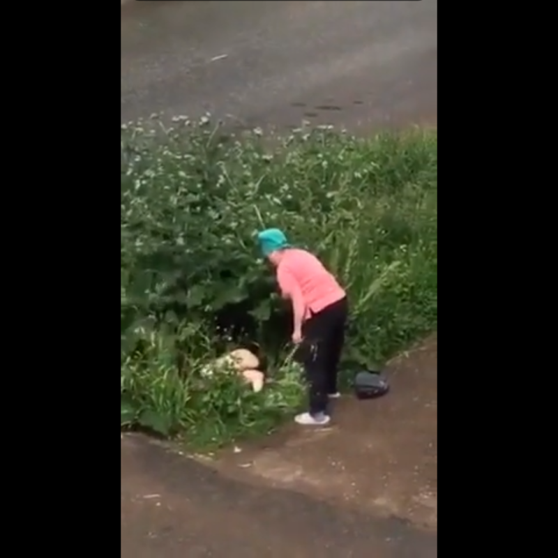 Woman urinates in the bushes